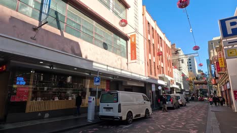 busy street with parked vehicles and pedestrians