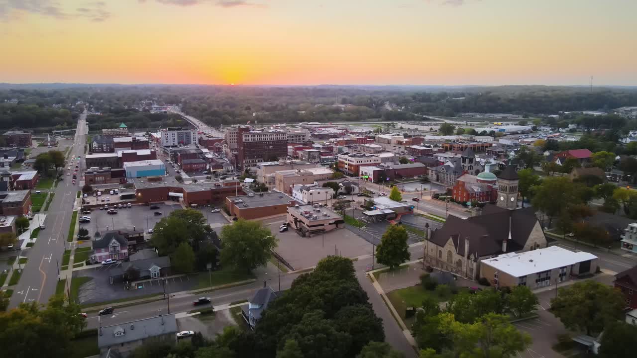 Aerial view of downtown Massillon, Ohio at sunset featuring historic buildings and streets. Dolly Backward Sunset W