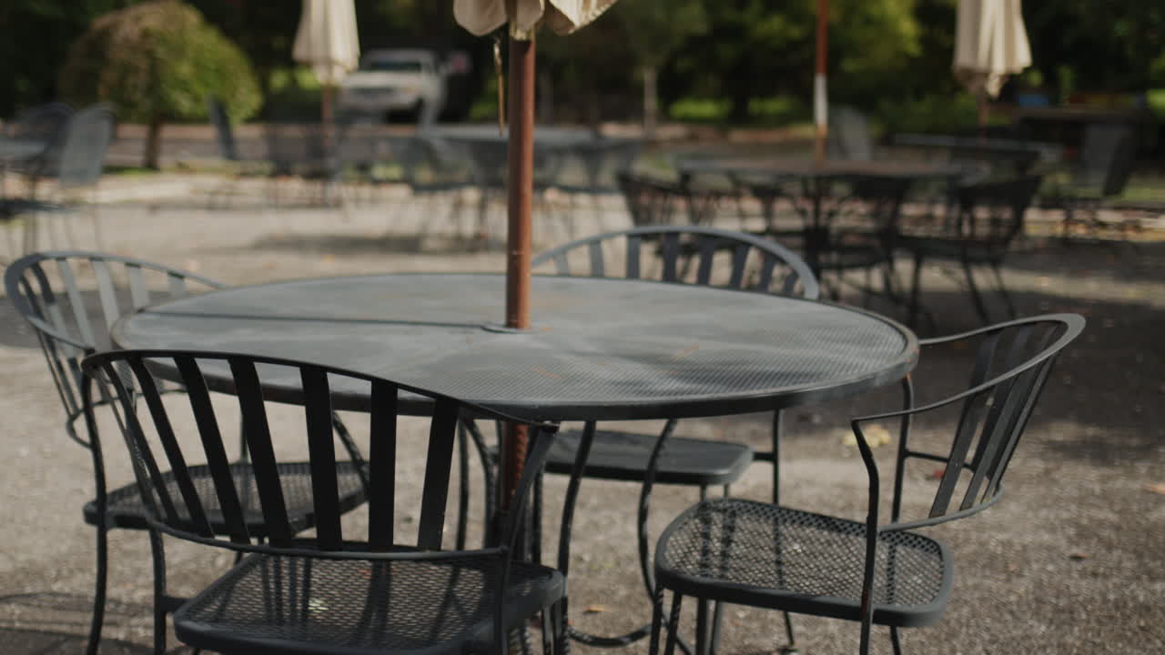 The summer terrace of the restaurant without visitors - empty tables and chairs.
