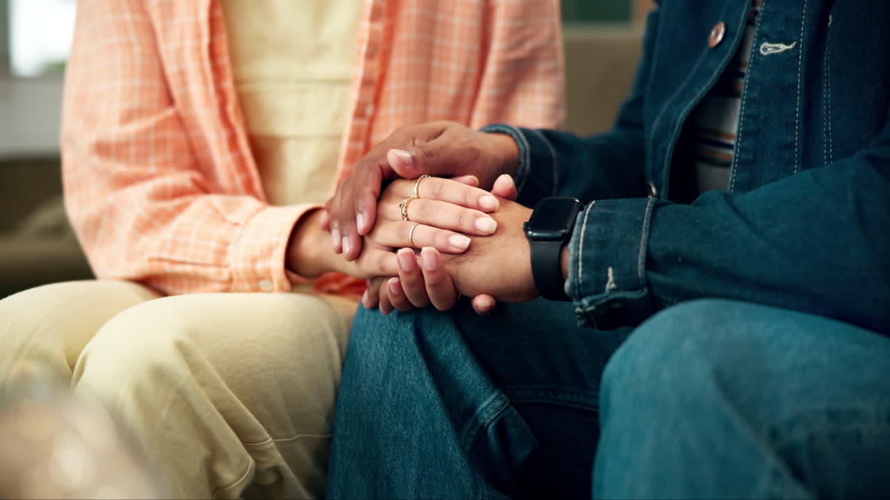 Couple Holding Hands in a Moment of Support