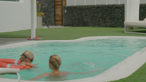 family cooling off and having fun in the swimming pool