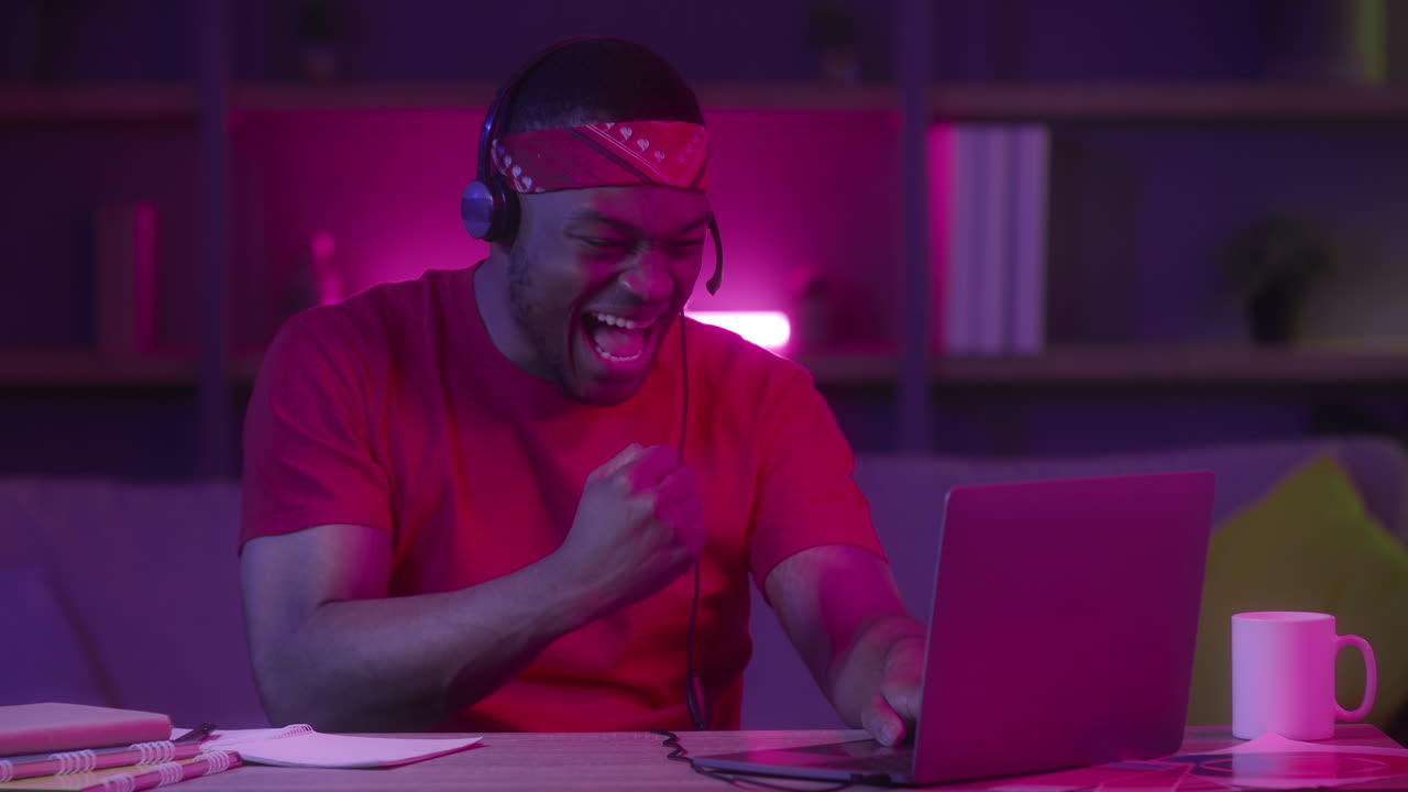 Ein glücklicher Mann feiert seinen Erfolg auf einem Laptop