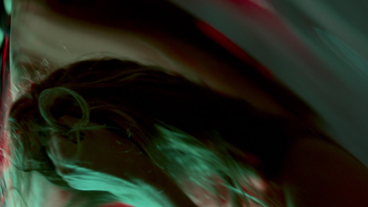 Dancer Showing Emotion through Movement in front of Distorted Reflection