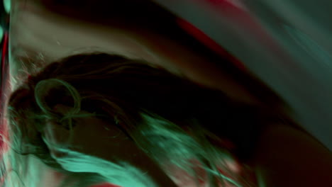 dancer showing emotion through movement in front of distorted reflection