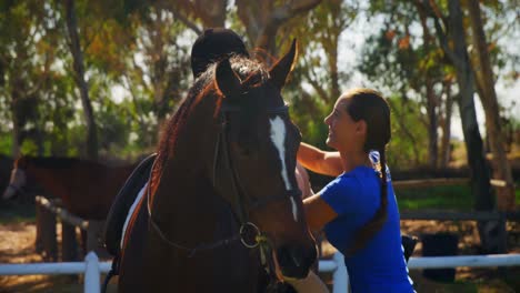 mother assisting daughter during horse riding 4k