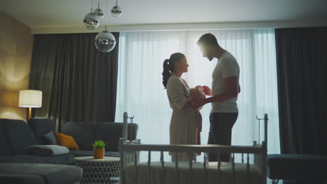 happy parents with newborn baby in the living room