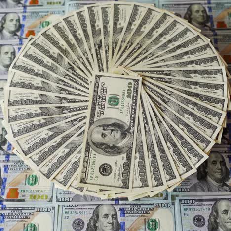 circular arrangement of one hundred dollar bills