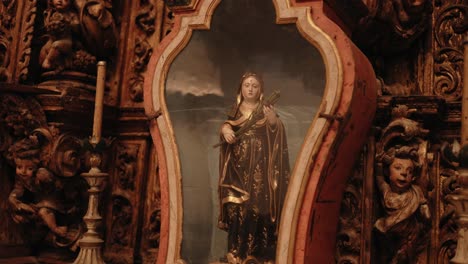 religious painting in ornate baroque frame with gold angel carvings