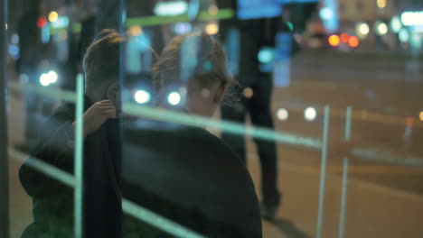 mother and son waiting at the city bus stop