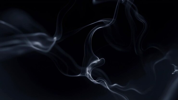 Delicate translucent smoke ribbons curl and drift across deep black studio background, forming soft loops, layered wisps, and slender trails with pearlescent highlights, subtle sheen, and