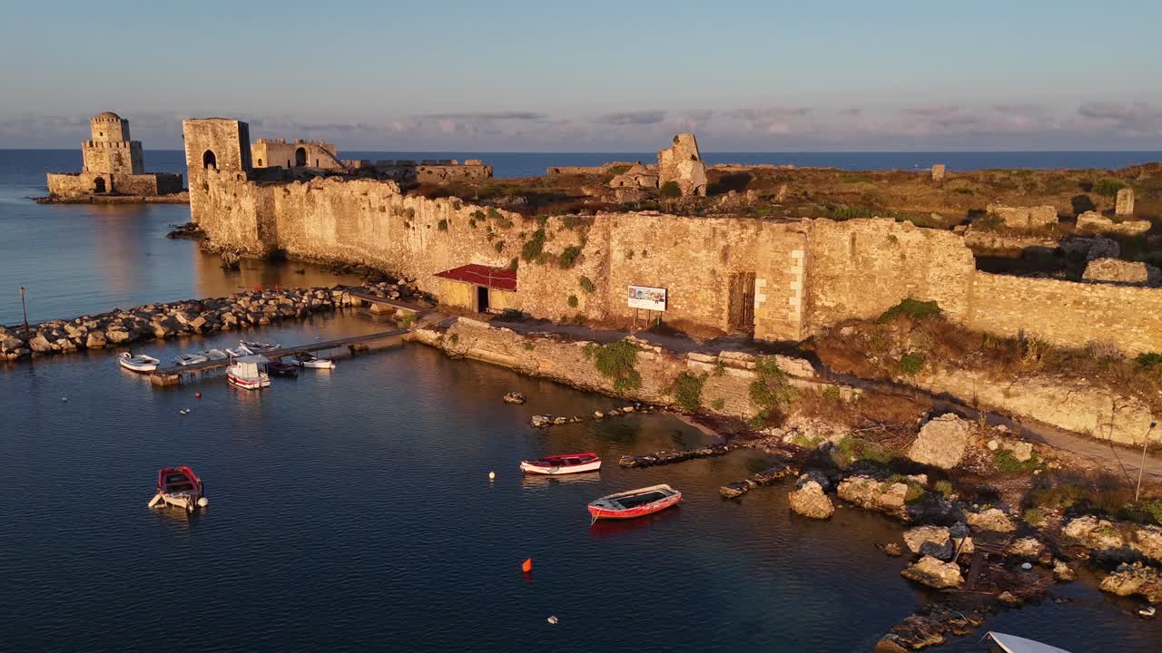 Methoni,Messenia,Peloponnese,Aerial view forward along the Methoni Castle towards Bourtzi Tower and the open sea during golden hour. Background is the open sea and clouds on the horizon