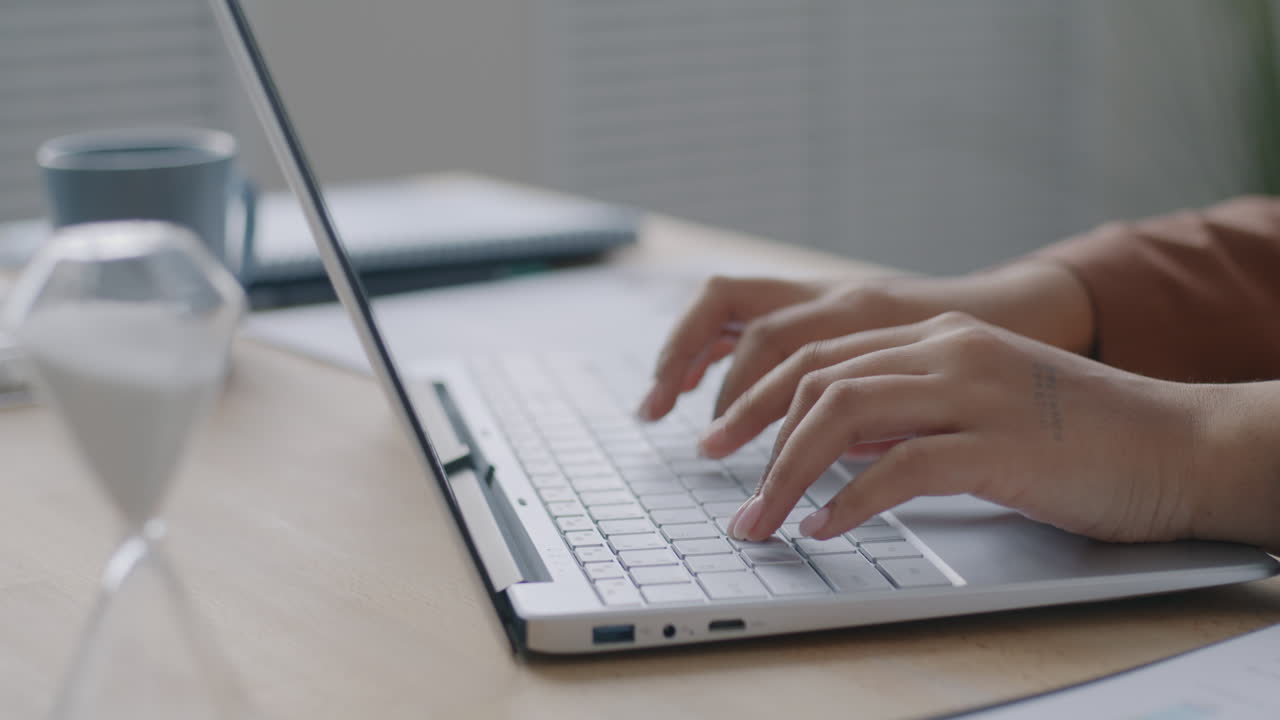 Woman Typing on Laptop at Desk