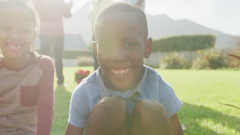video of happy african american family spending time together in the garden