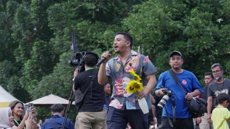 indonesian singer and songwriter sal priadi performing on stage during sunset di kebun concert on kebun raya bogor, indonesia. slow motion shot