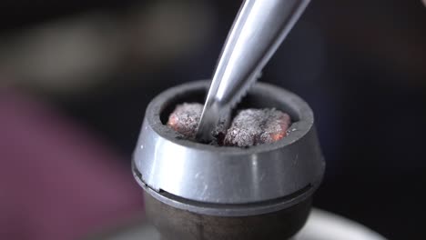 adding charcoal to a hookah