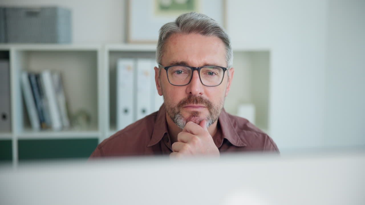 Thoughtful Businessman Working on Computer in Office