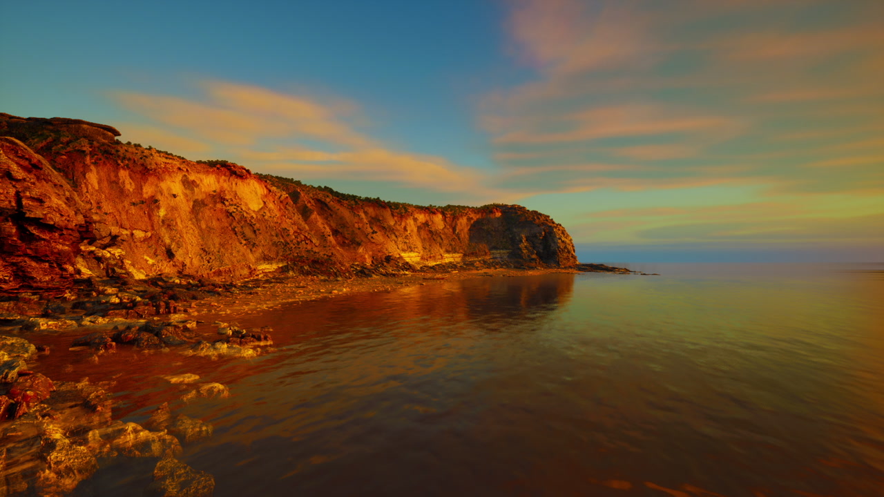 Early daylight softly influences rocky coasts and peaceful waters