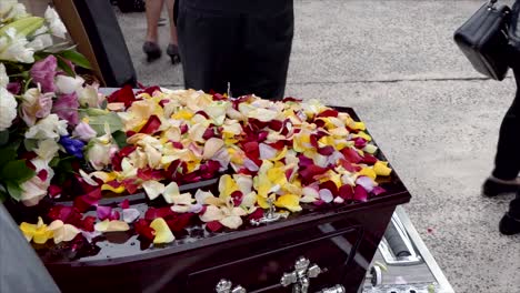 closeup shot of a funeral casket in a hearse or chapel or burial at cemetery