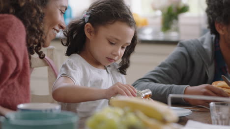 happy family eating waffles for breakfast with children enjoying delicious treat in kitchen at home