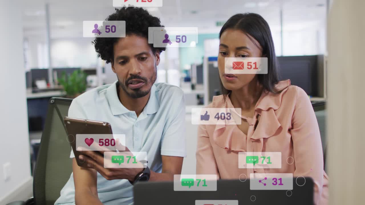 Colleagues tapping tablet and analyzing social media metrics with animated icons rising then fading