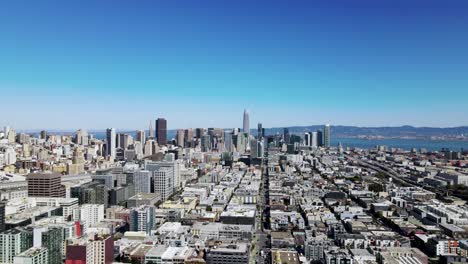 aerial drone view of san francisco skyline famous downtown buildings, ocean and mountains in the background