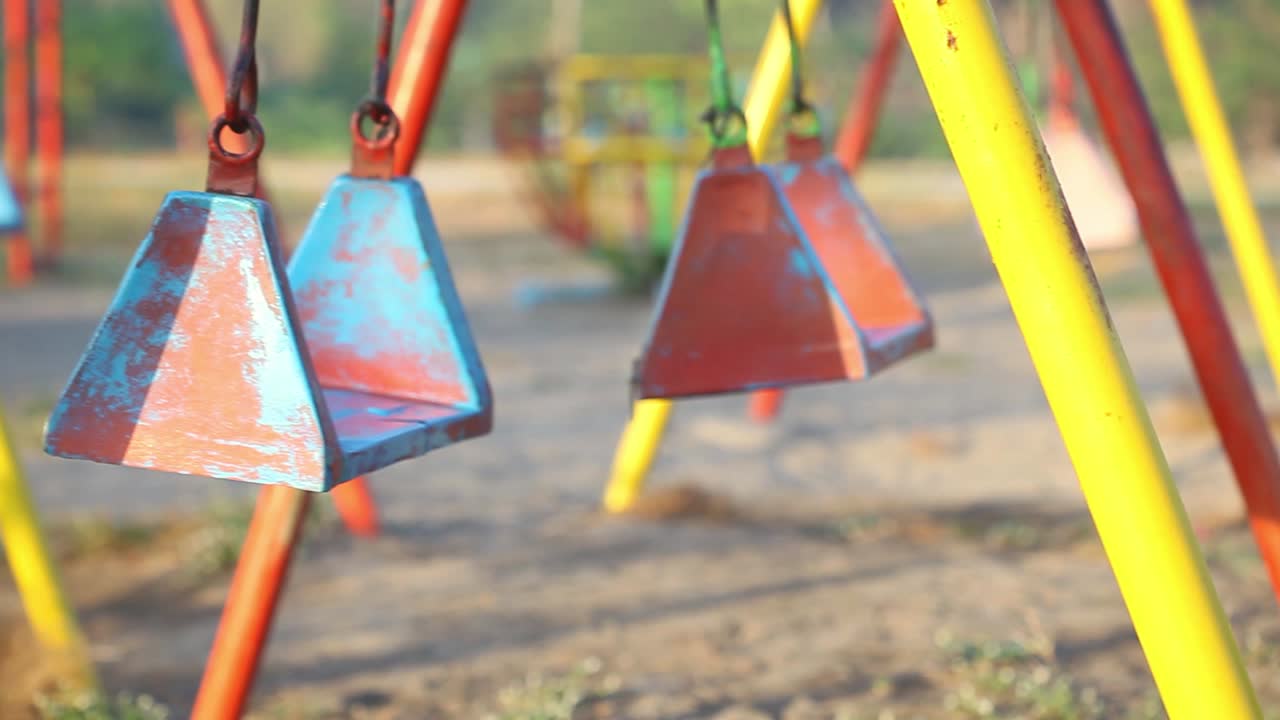 Empty swing on children playground during state of emergency by the reason of covid-19 virus threat