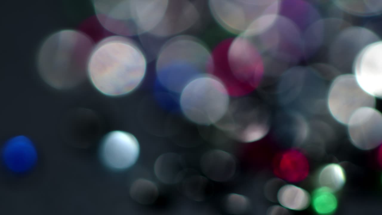 Multicolored light leaks 4k footage on black background. Stylizing video, transitions. Bokeh effect