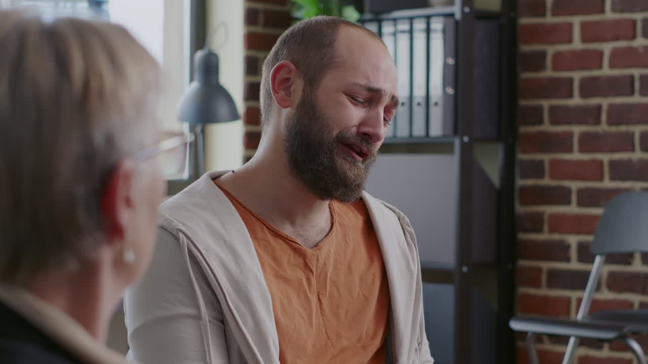 Close up of man with nervous breakdown sharing addiction story with people at aa group meeting