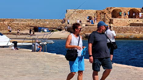 tourists sightseeing remnants of crete in chania, greece, mediterranean landscape panoramic