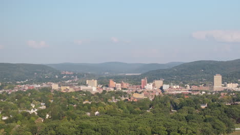 Aerial View of a City Skyline Surrounded by Mountains and Trees