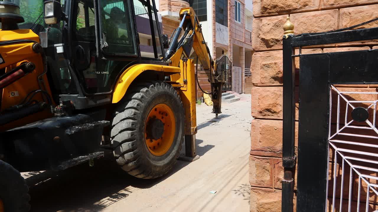 construction digger operating on road under daylight