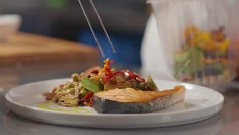 chef decorating dish with leaves