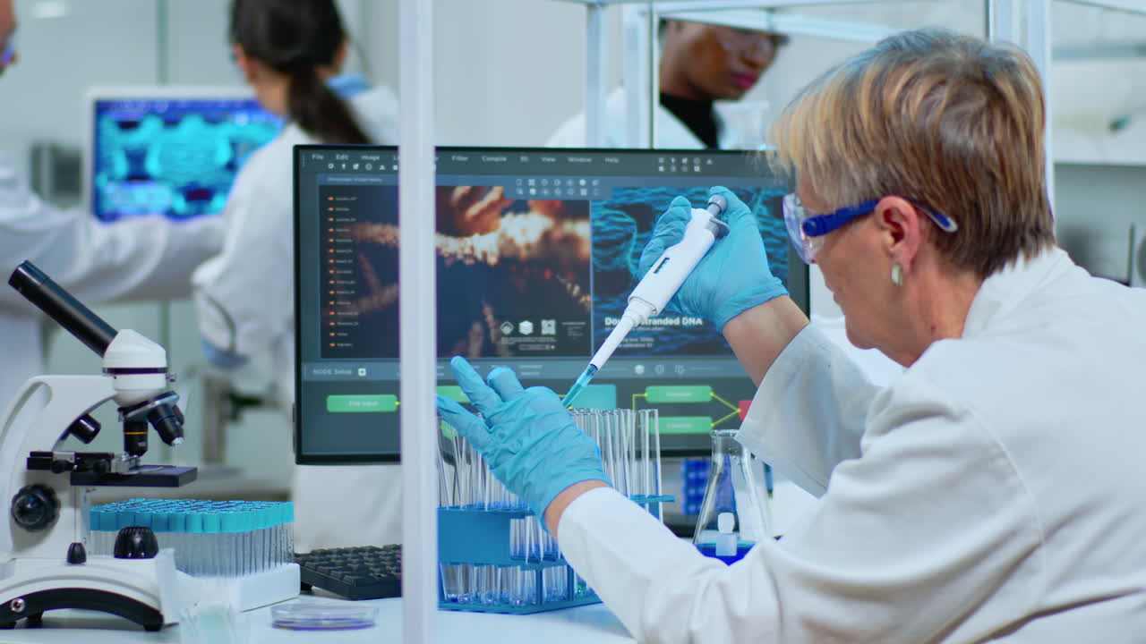 Elderly research scientist using micropipette filling test tubes