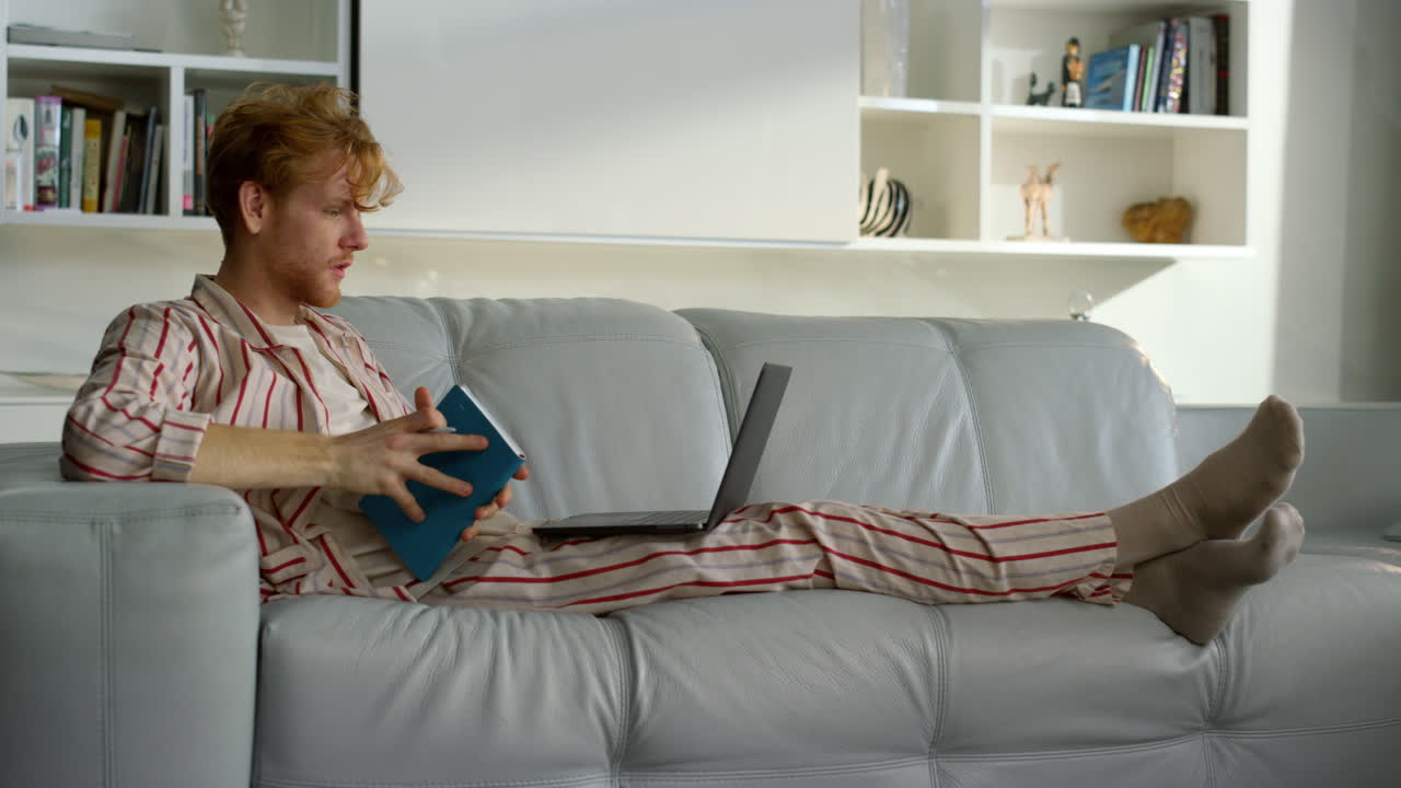 Freelancer making notes browsing web on weekend. Happy student studying home