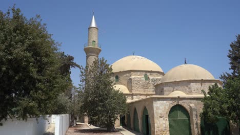 larnaca, cyprus, september 2021: hala sultan tekke mosque on the background of a salt lake. dried up salt lake. natural salt on the surface of the earth.