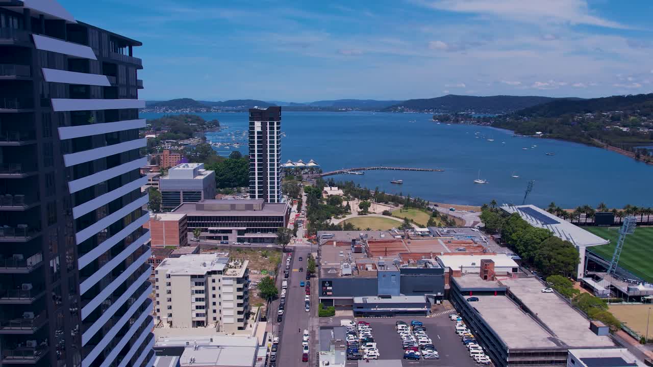 Cinematic 4K aerial drone footage flying past the brand-new Voco Gosford hotel by IHG, showcasing the modern skyline of Gosford on the New South Wales Central Coast