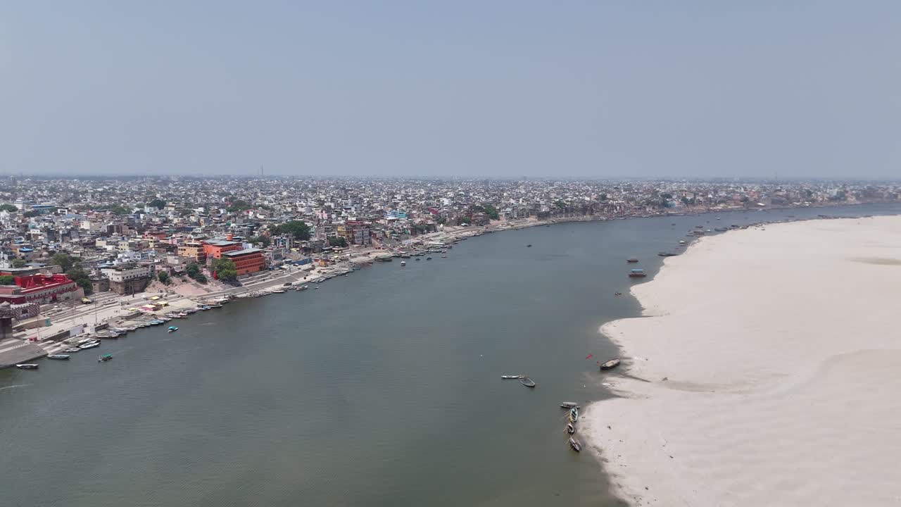 Aerial capture of the densely packed housing of Varanasi, where the sounds of temple bells and street vendors echo through narrow lanes.