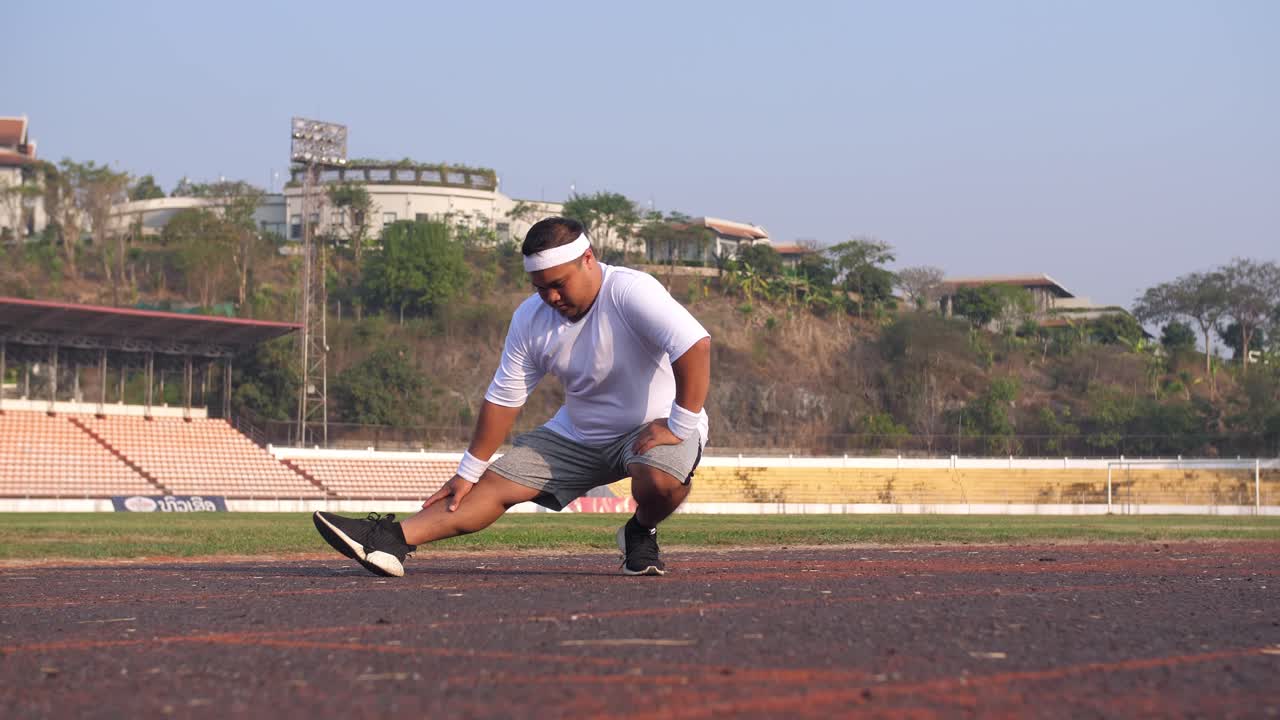 Fat Man Stretching Legs Before Run