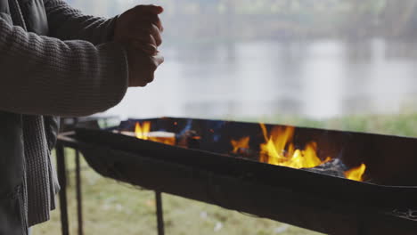 Hände,-Camping-Und-Feuer-Mit-Einer-Person-In-Der-Natur