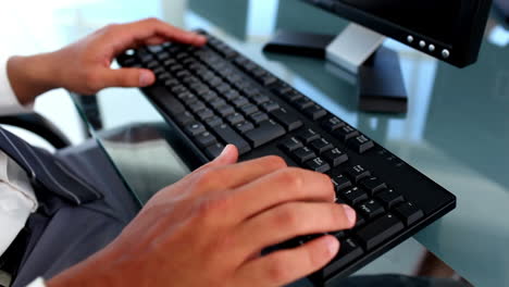 hands typing on a keyboard