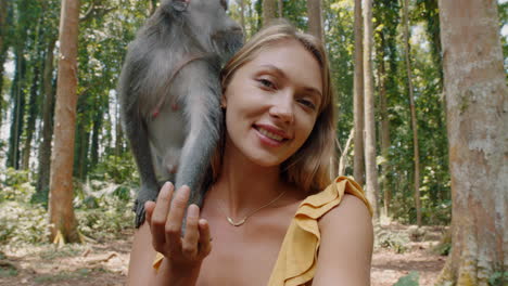 pov-happy-woman-video-chatting-with-monkey-sitting-on-shoulder-vlogger-girl-looking-at-camera-filming-travel-adventure-at-zoo-for-wildlife-vlog-sharing-experience-on-social-media