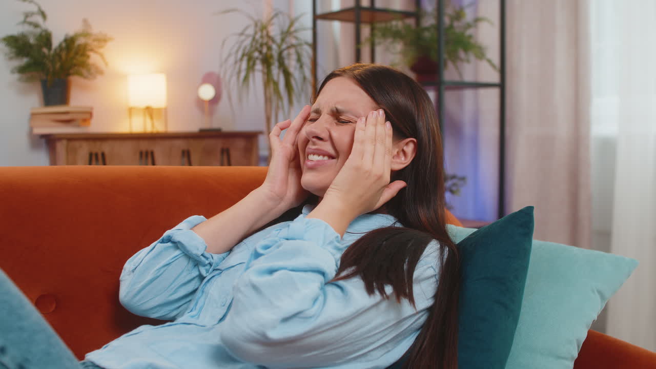 Sick ill caucasian woman suffering from headache problem tension and migraine grimacing in pain