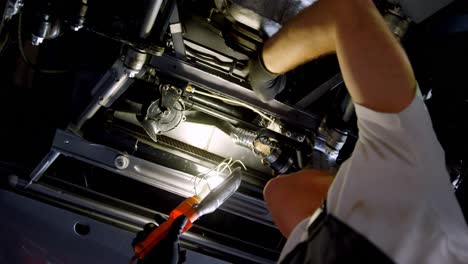 male mechanic servicing a car in garage 4k