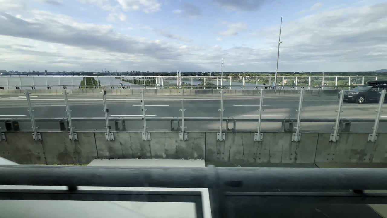 Driving on a highway bridge with a scenic city view