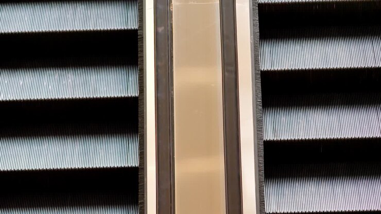 Close up of moving empty escalator in operation, 4k footage, nobody, up and down side by side shot.