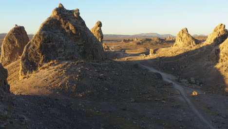 Flying-over-a-dirt-road-going-through-the-Trona-Pinnacles-in-the-Mojave-Desert-at-sunrise