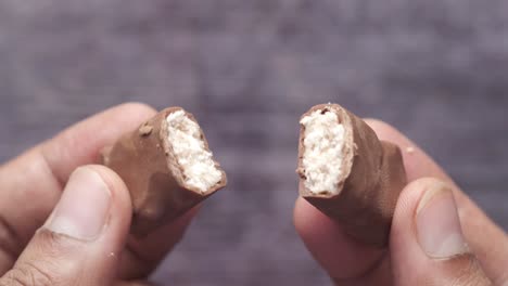 broken chocolate bar in hands