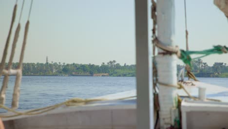 View-from-sailboat-deck-with-mast-and-rigging-to-coast-of-Cairo,-Egypt