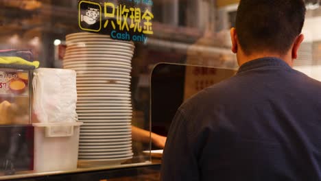 man orders at a dessert bakery counter