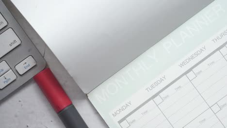 monthly planner with keyboard and pen